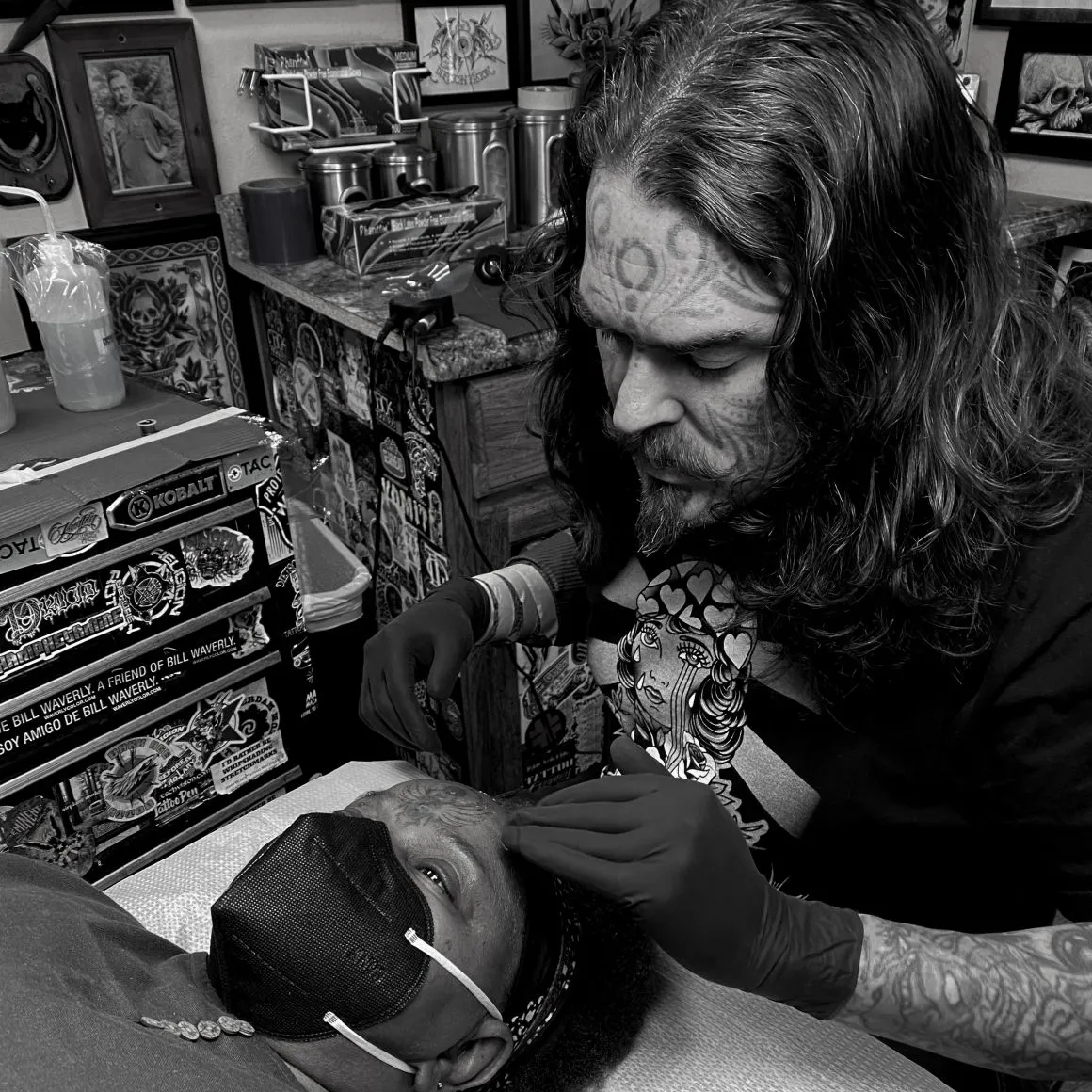 Close-up of an artist's hands tattooing