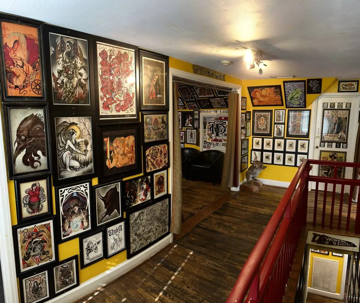 Framed flash covering the walls along the staircase