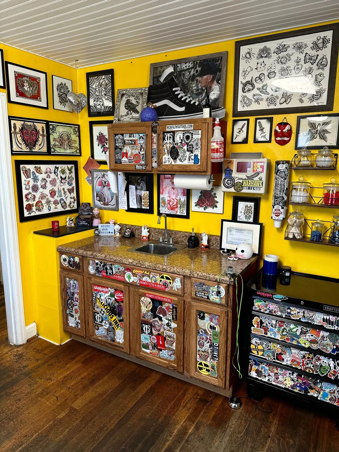 Work station surrounded by framed flash and stickers